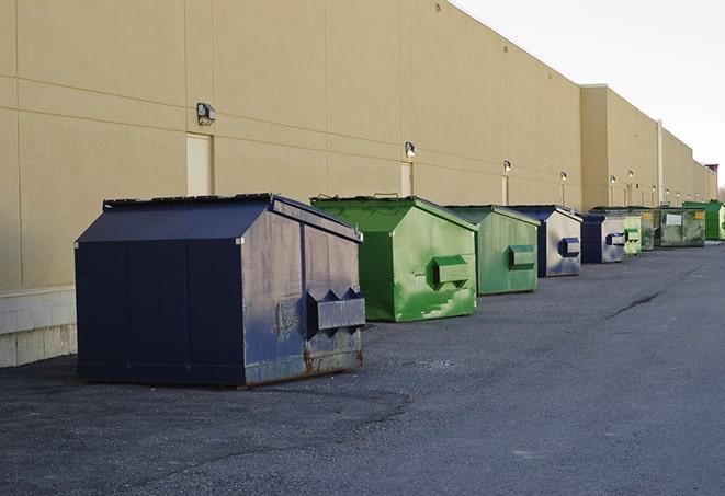 a crowd of dumpsters of all colors and sizes at a construction site in Coldspring